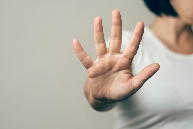 Gender,Based,Violence,Concept:,Woman,Stretches,Her,Arm,To,Try